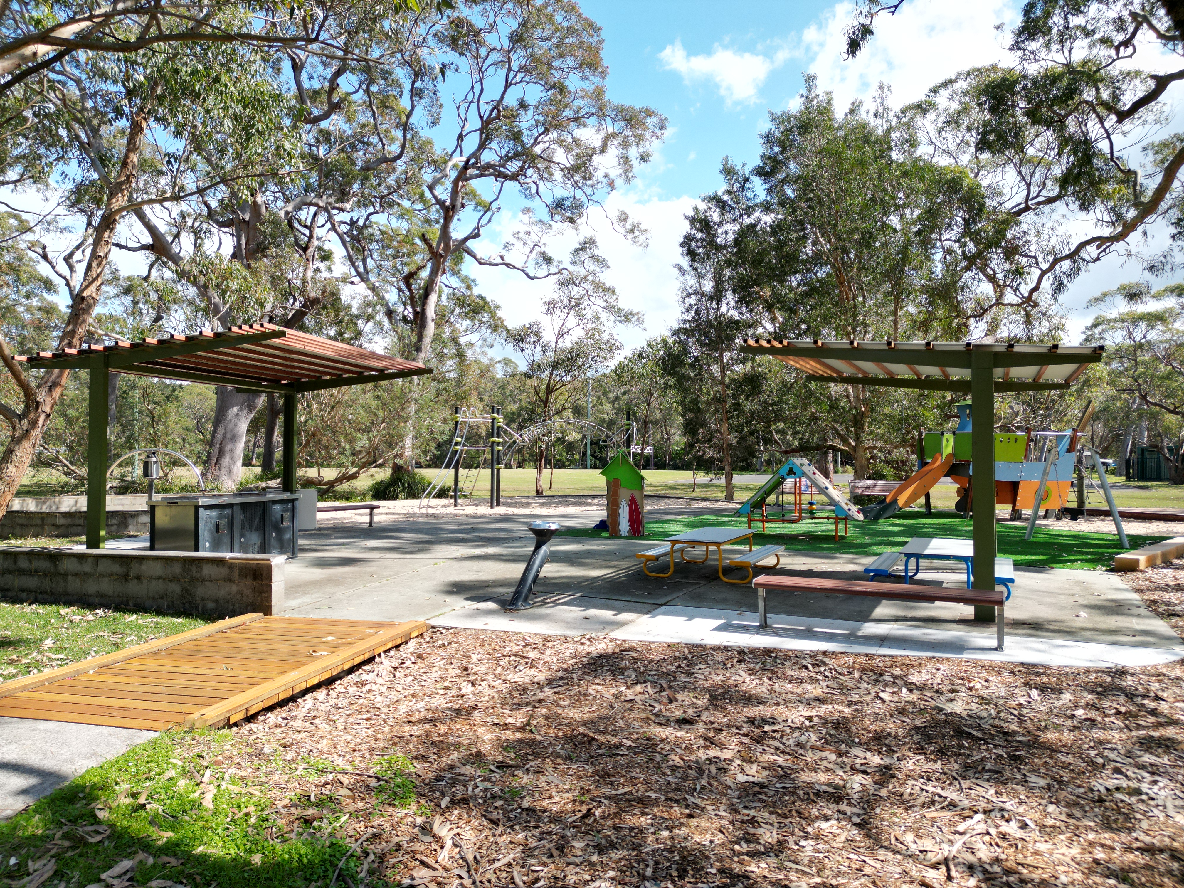 Park with picnic facilities, pathway and play equipment