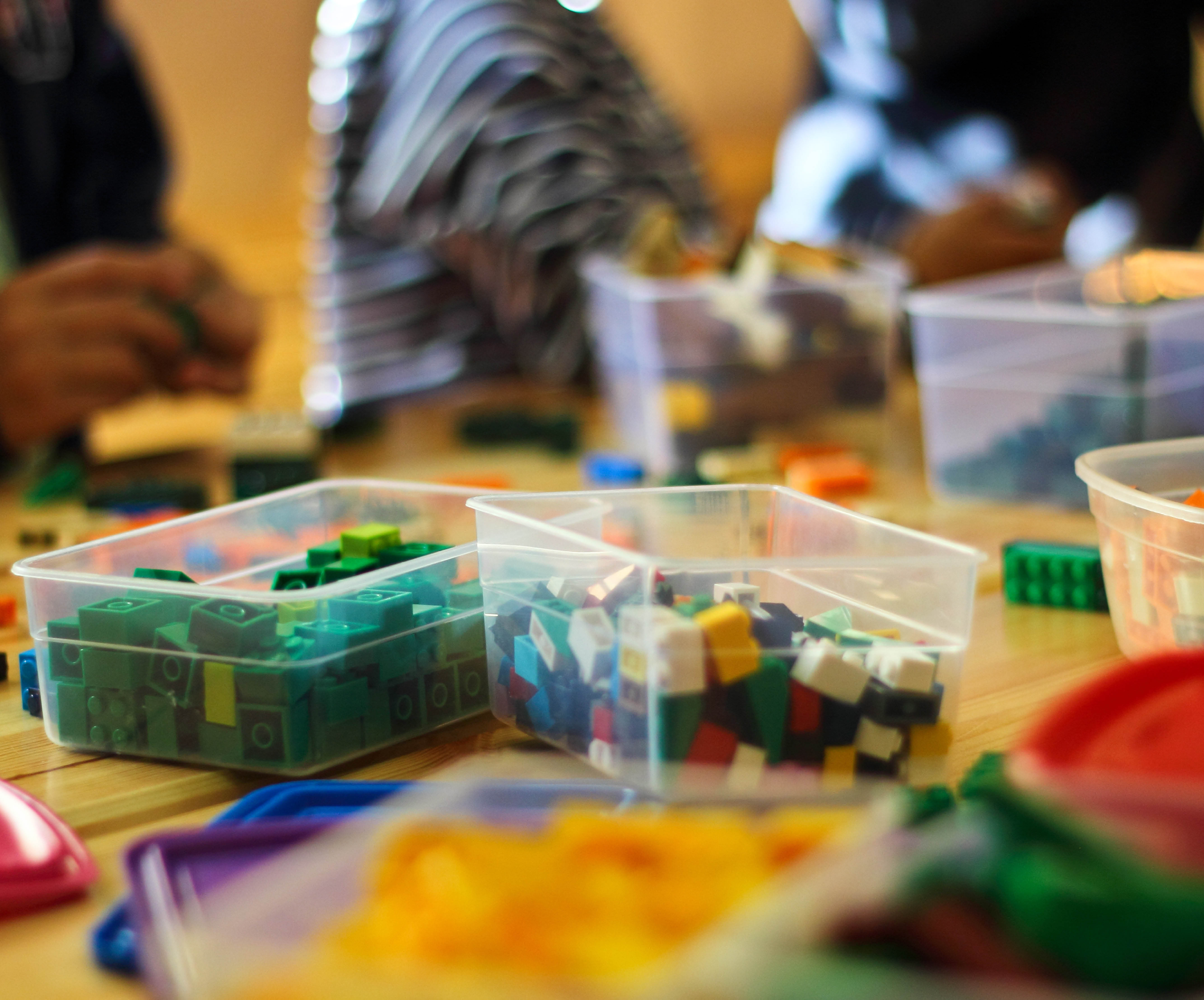 Group of young people building with Lego