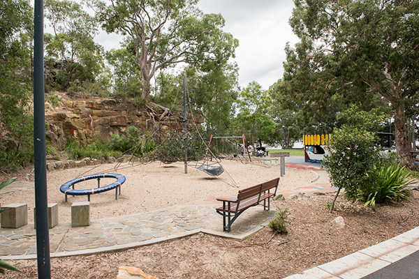 Playground with climbing net, carousel and swings