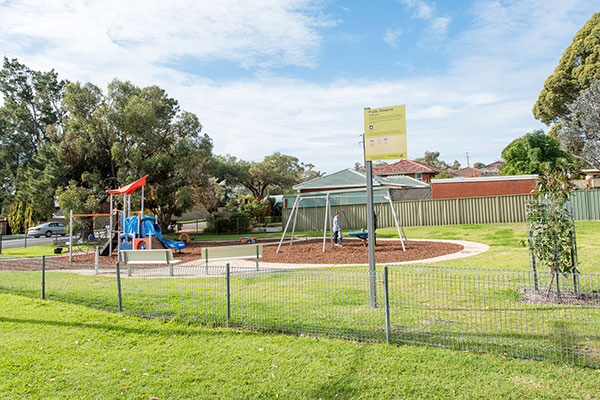 Playground in small local park with grassed areas
