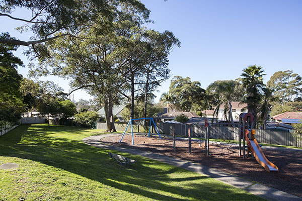 Playground with swings, climbing net and slide