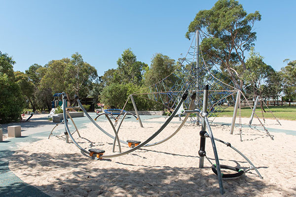 Playground with climbing net and sand softfall