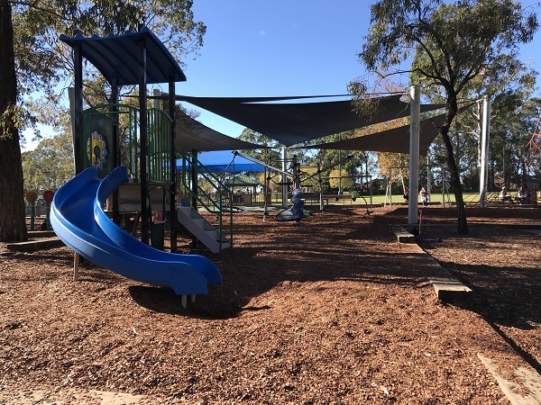 Playground with shade sails, slide and bark softfall
