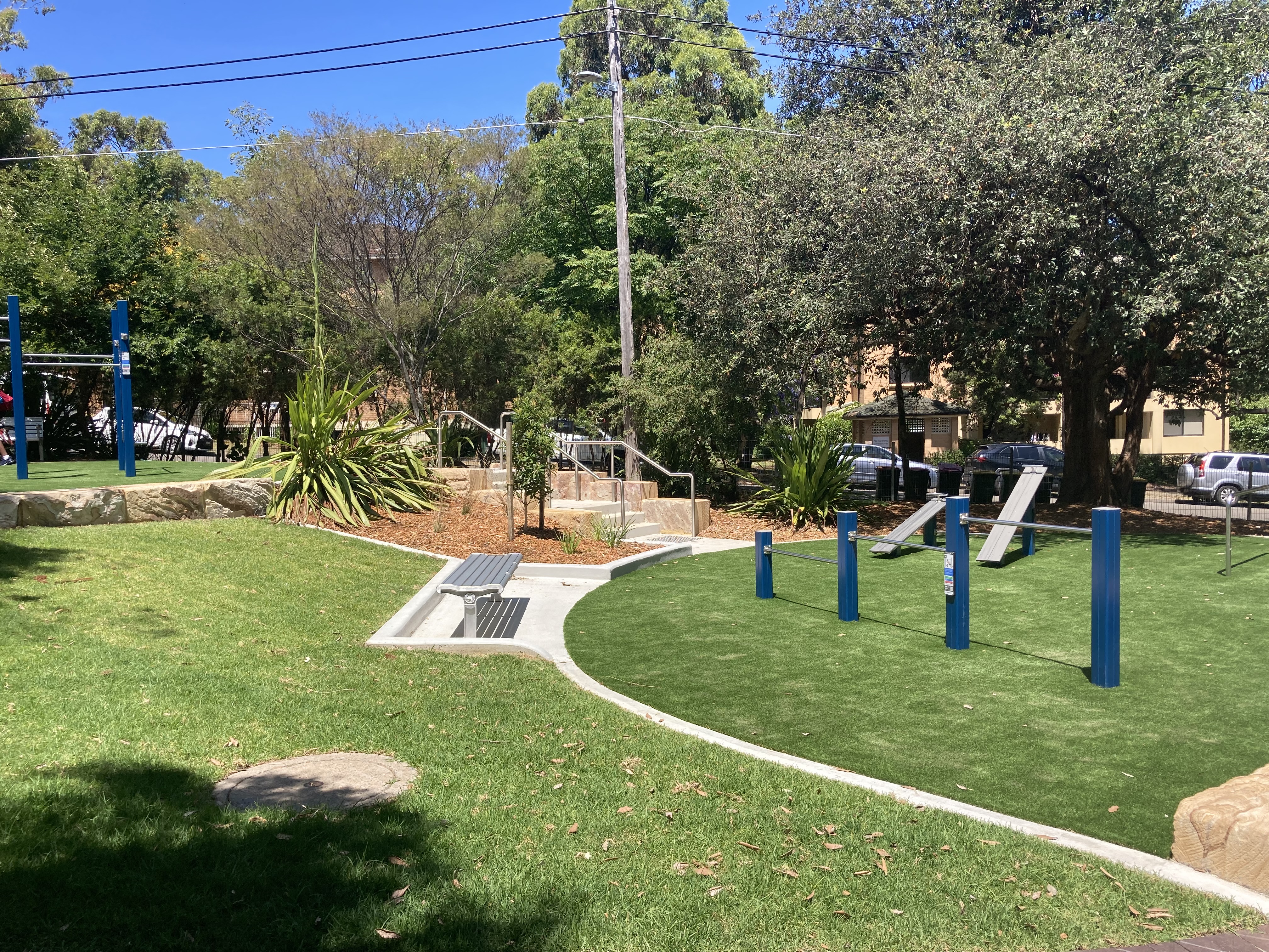Shady park with fitness equipment