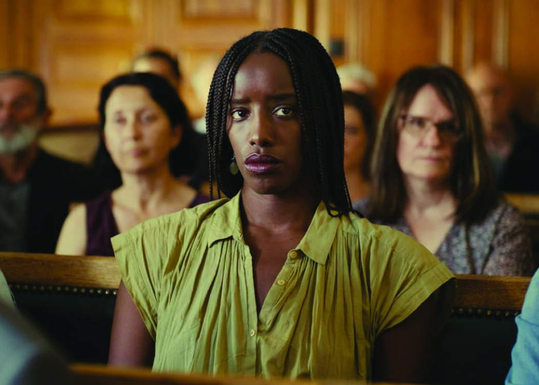 A black woman sitting in a court room.