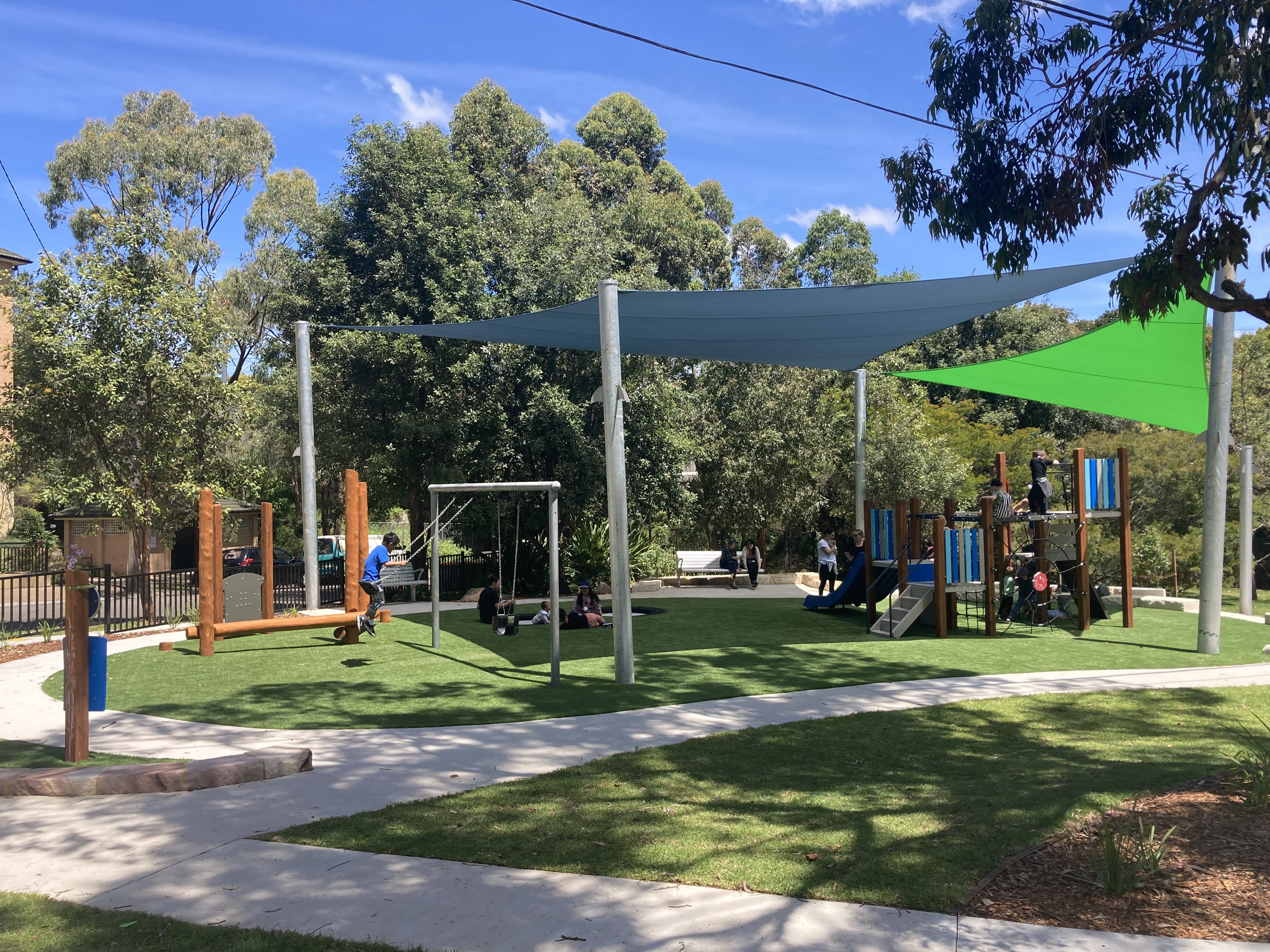 Park with shaded playground and footpath