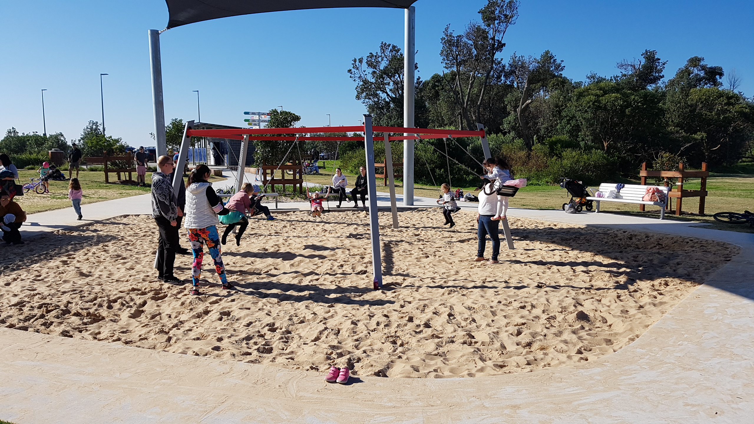 Children using multiple swing set