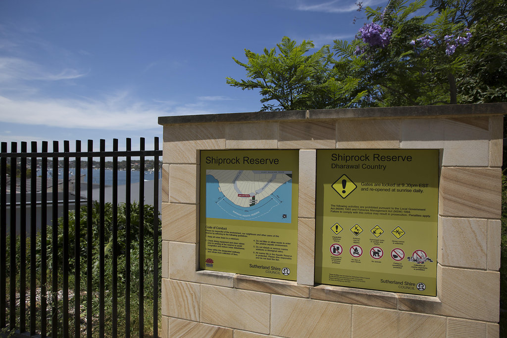 Sandstone wall and interpretive signs