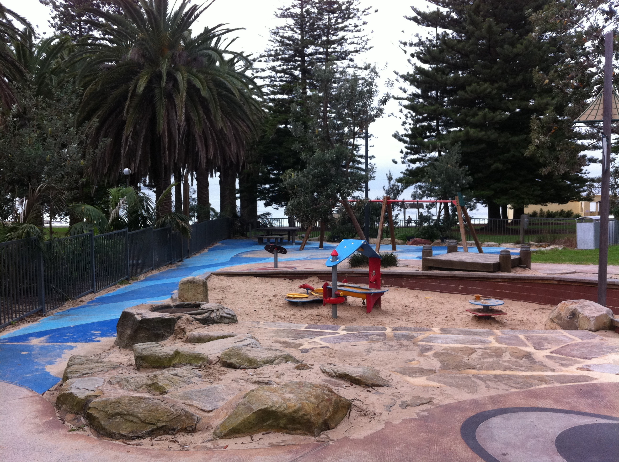 Playground with carousel, swings and paths