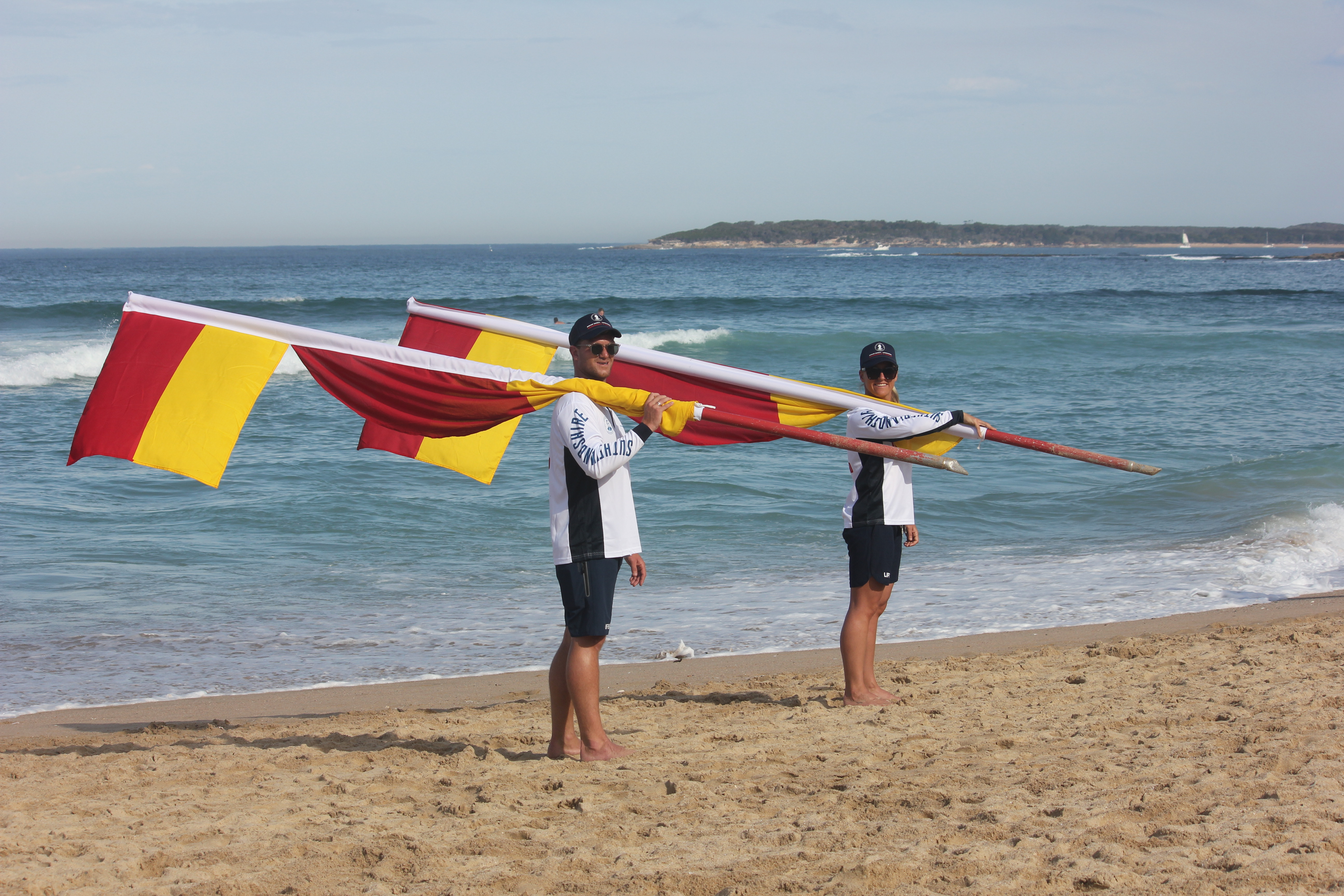 Lifeguards holding flags