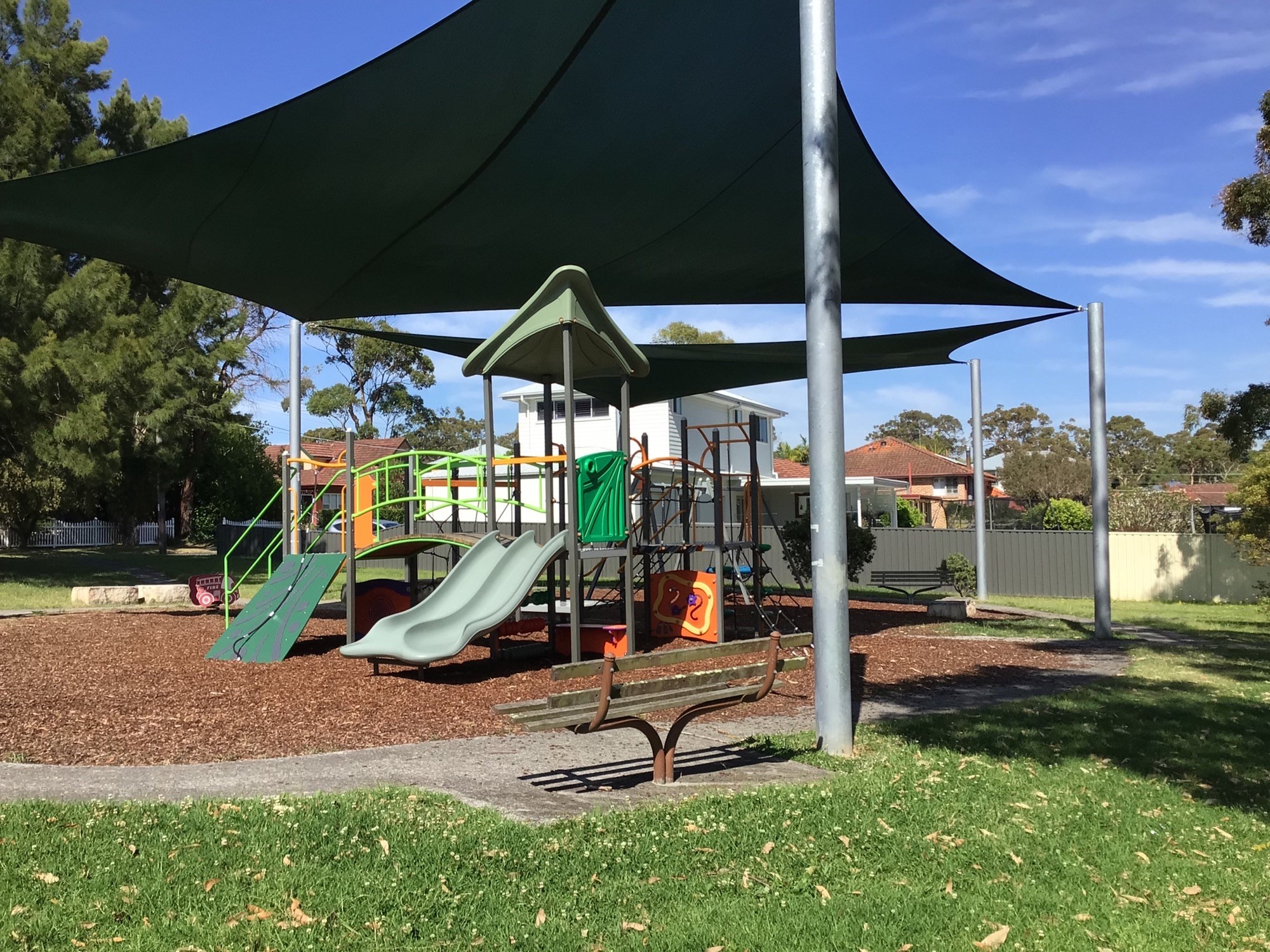Park with shade sail and slide