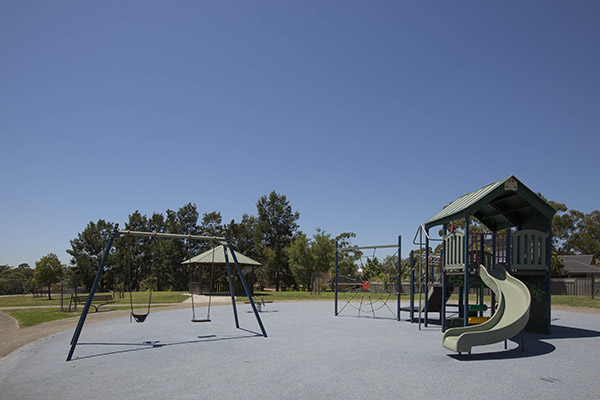 Playground and swings on synthetic softfall