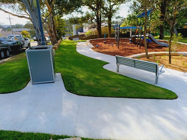 Park with playground, scooter path and grass