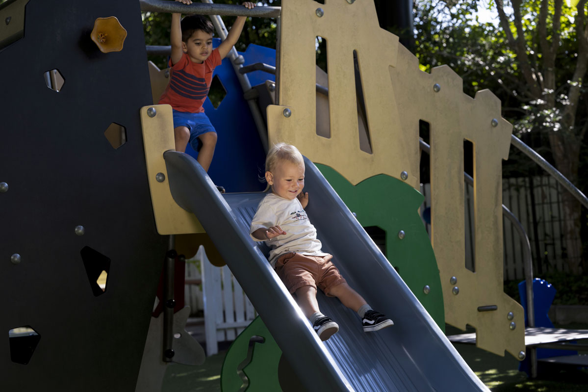 young child going down a playground slide