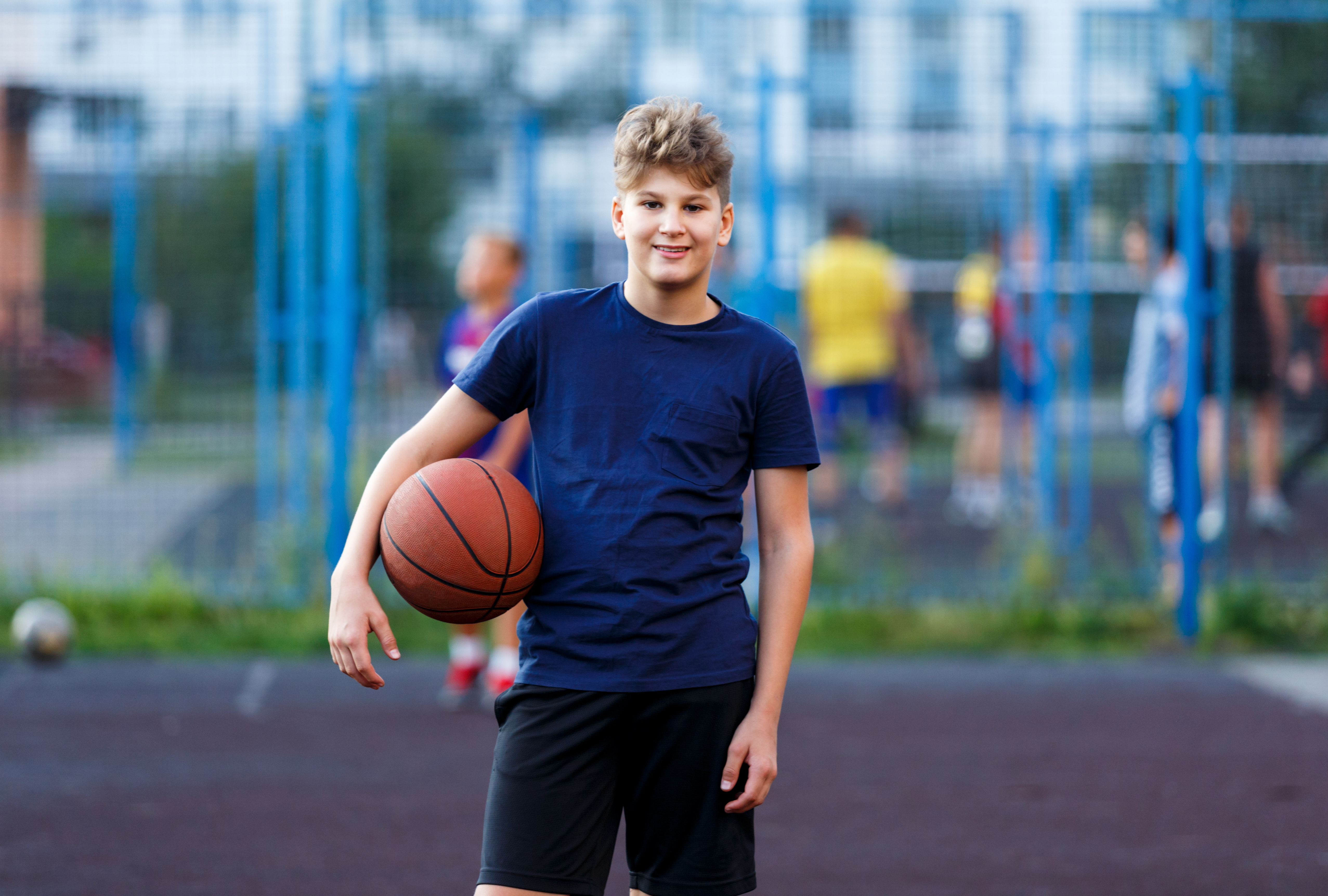Young person holding basket ball