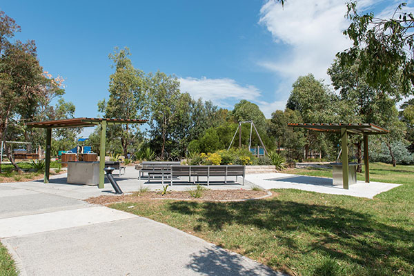 Park with picnic shelter, seating and playground
