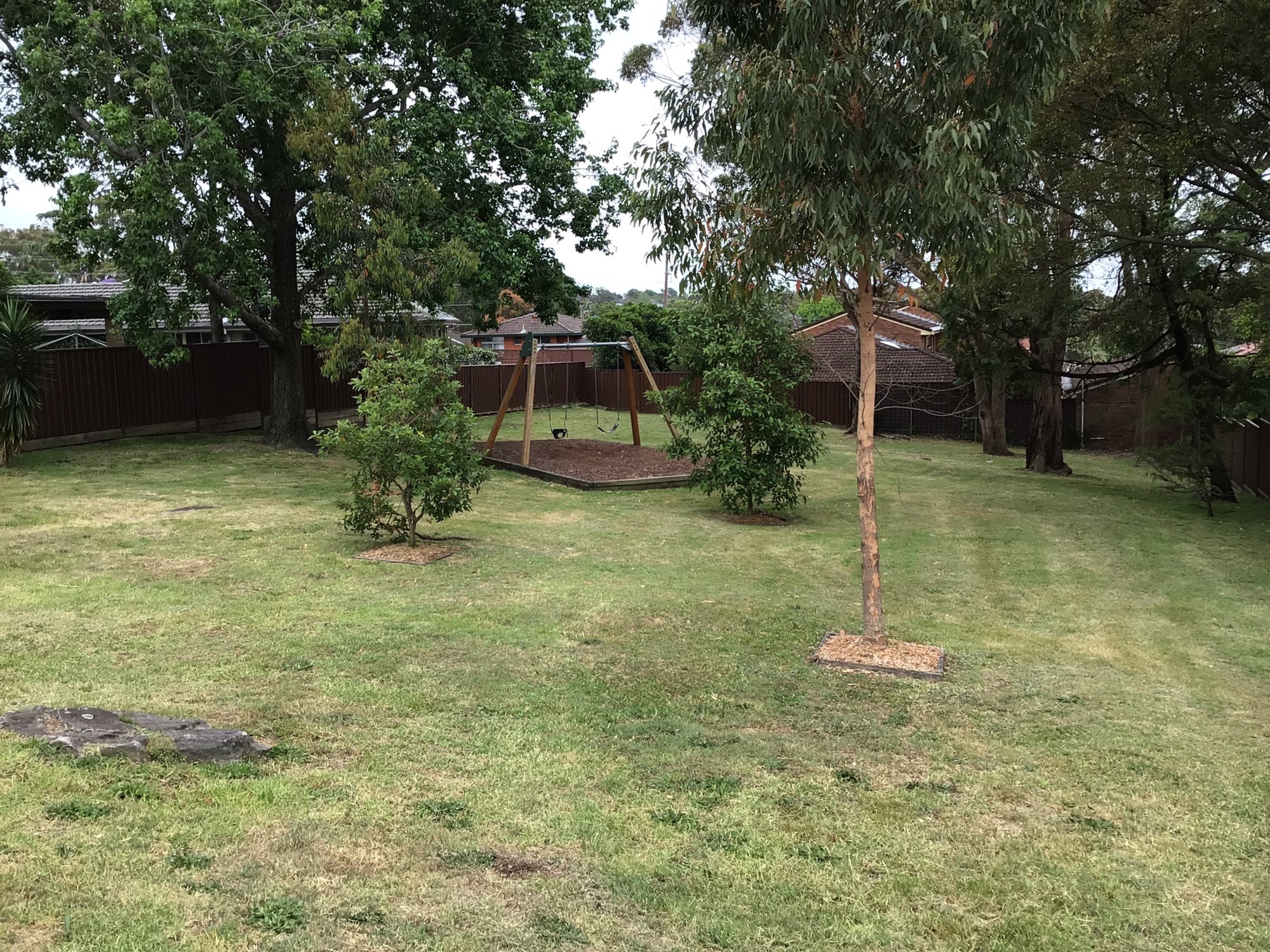 Park with swing set and trees