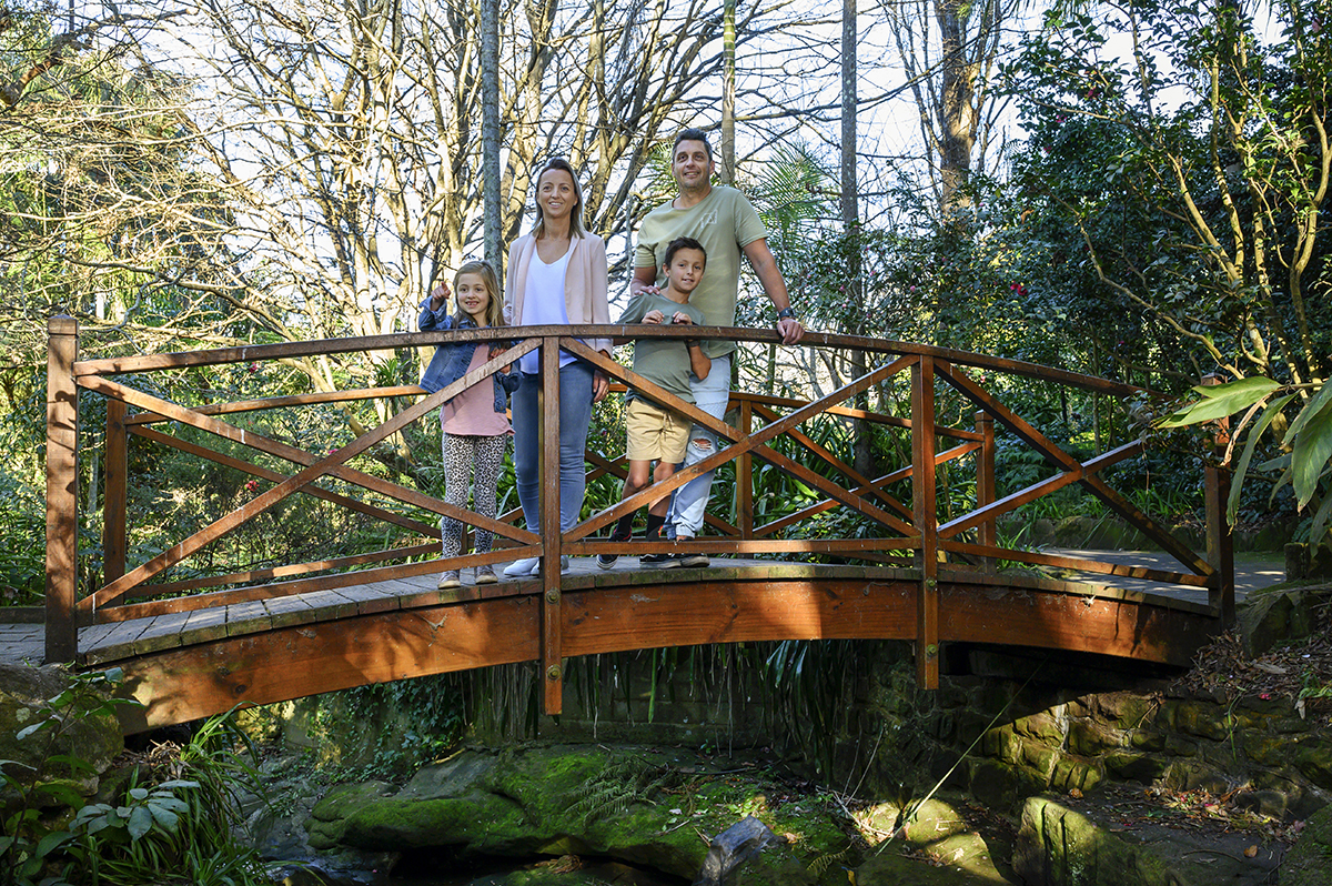 Family standing on bridge in C