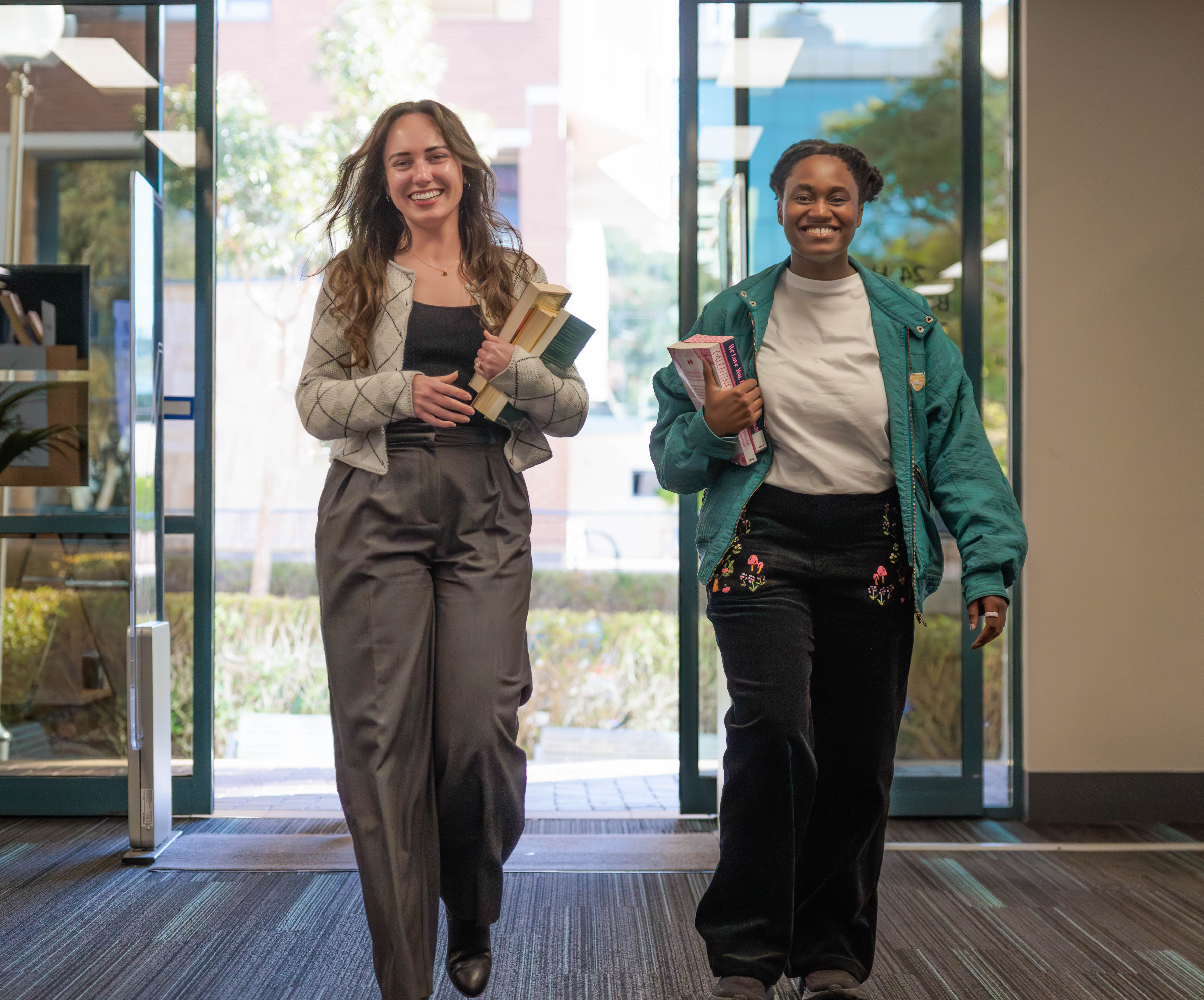 customers walking into sutherland library with books