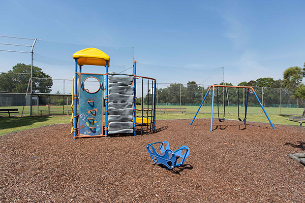 Play equipment with climbing tower, rocker and swings