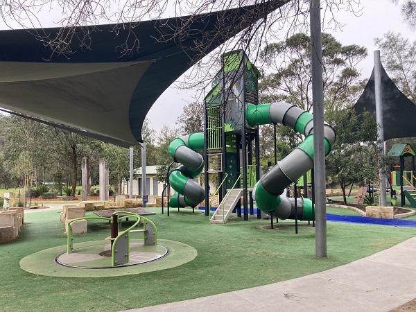 Large playground with carousel and double climbing tower