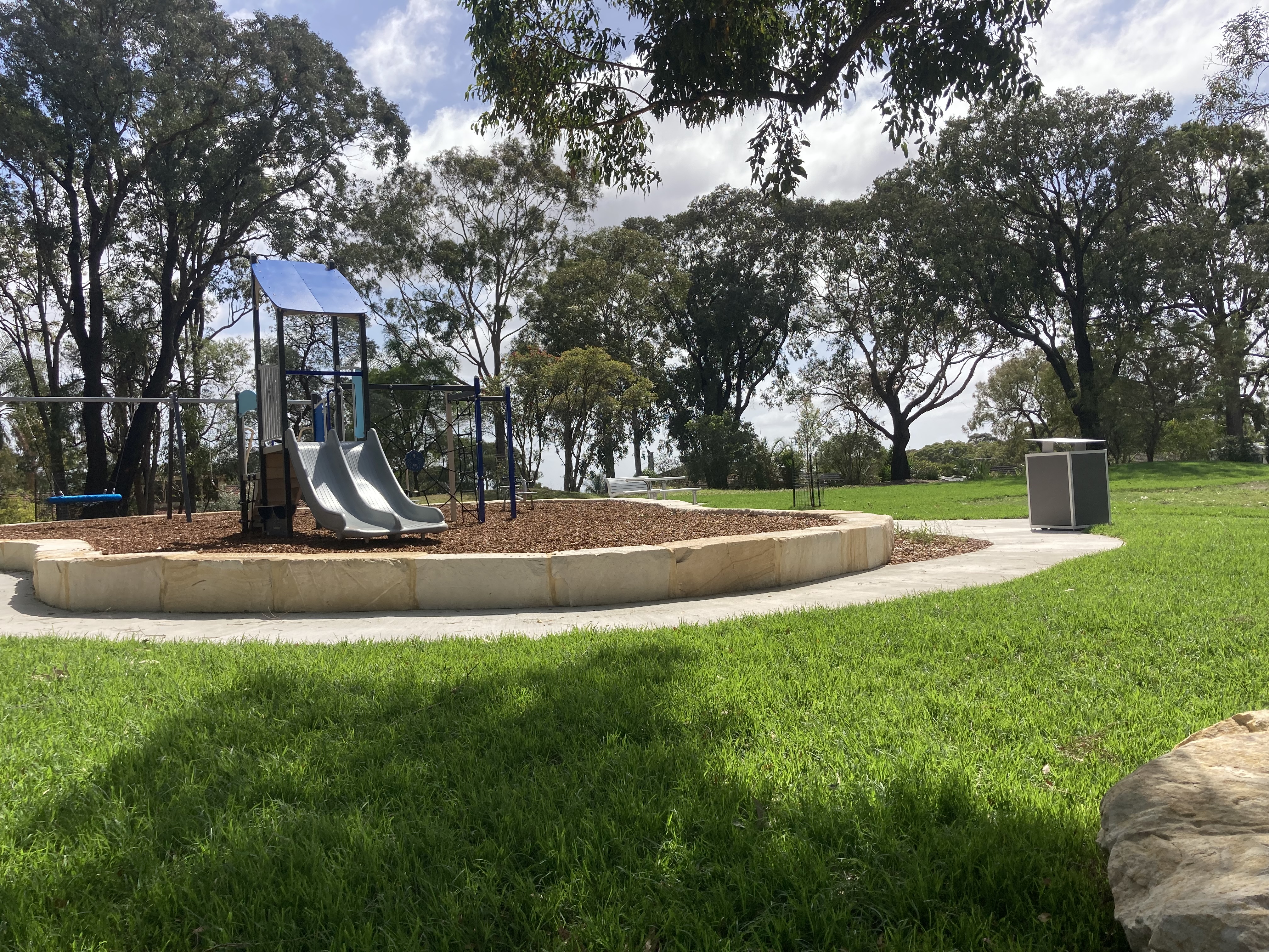 Leafy reserve with pathways and playground