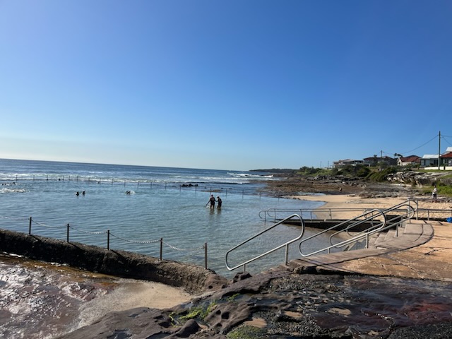 Swimmers in ocean pool and access ramp