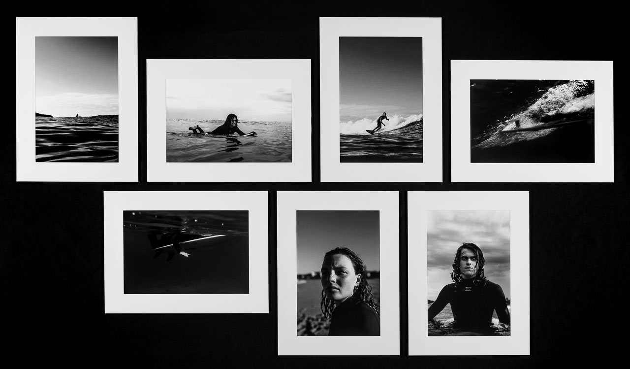 A series of seven black and white photographs of the artist's friends surfing.