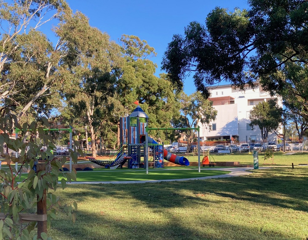 Playground with mature trees and scooter path