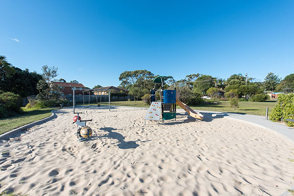 Playground with sand softfall in sunny reserve