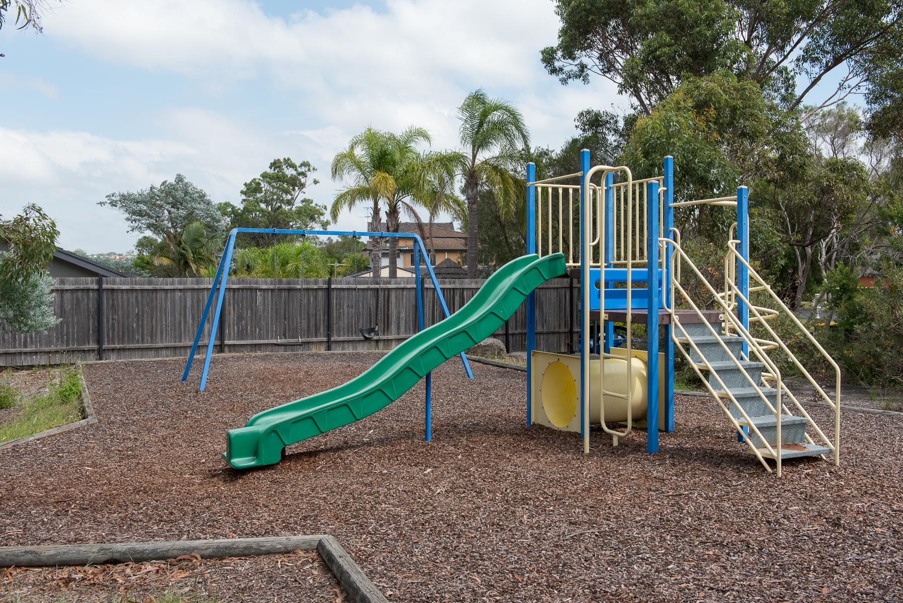 Playground with climbing equipment, slide and swings
