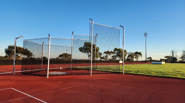 Running track with nets in background