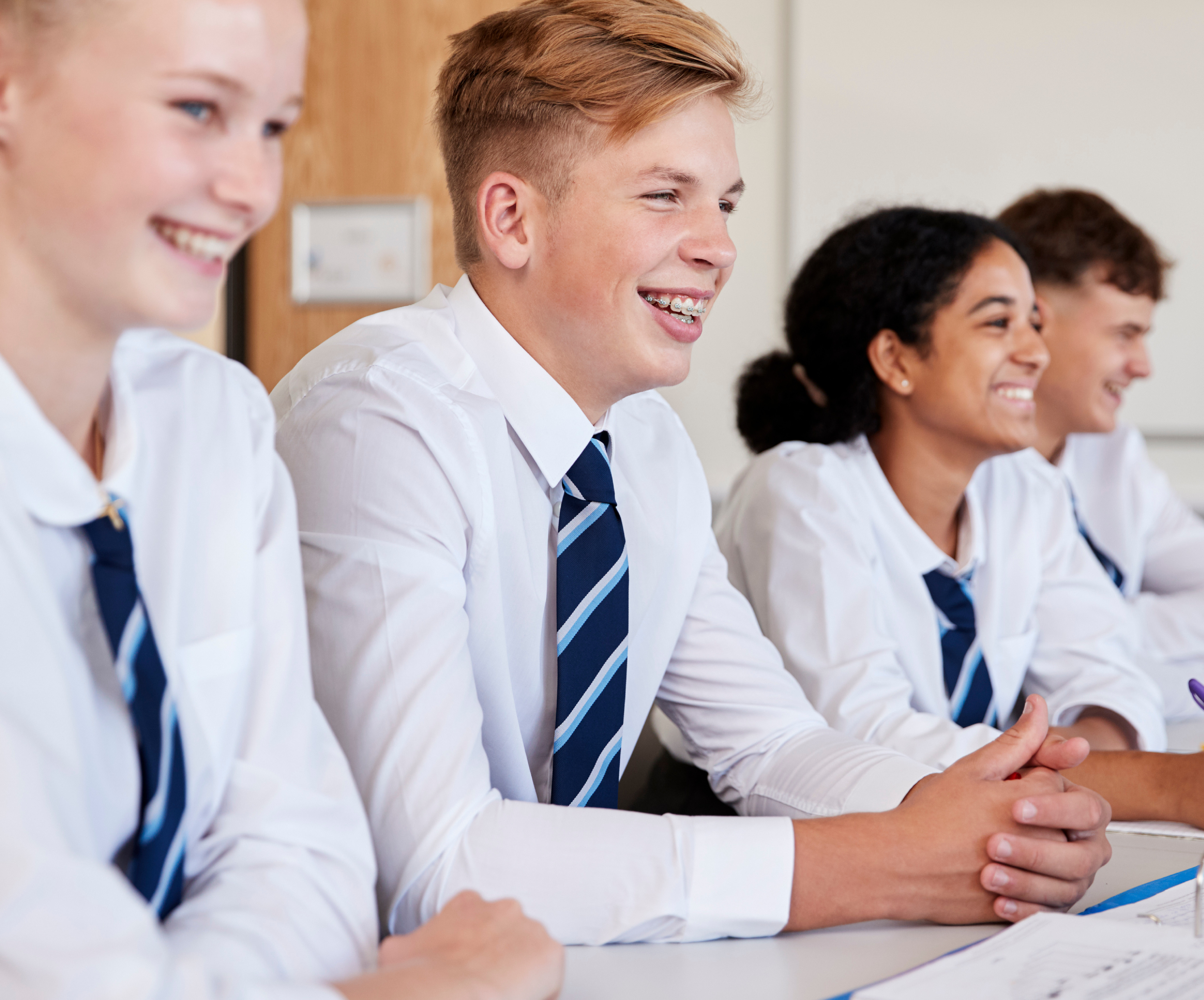 teens school uniform smiling in classroom