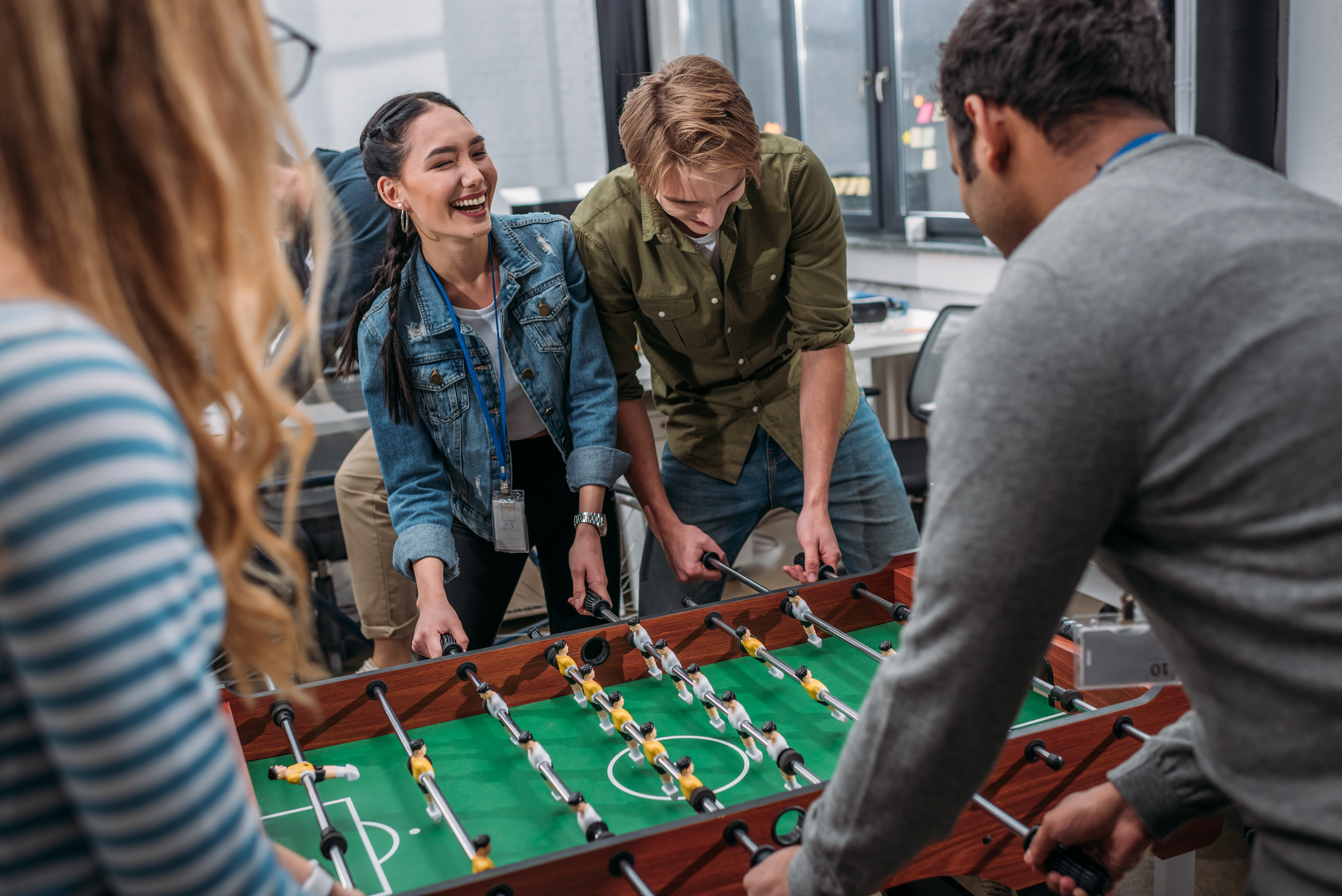 four teenagers playing fuseball