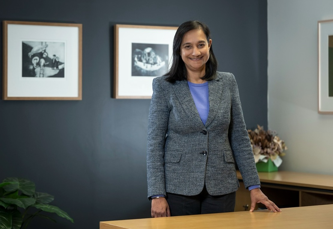 Sutherland Shire Council CEO, Manjeet Grewal standing alongside a desk inside an office