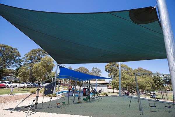 Playground with shade sail and swings